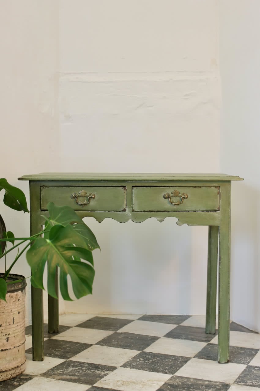 georgian painted pea green two drawer side table with pretty shaping on both front and sides, lovely brass handles and very old drawer lining paper inside.
