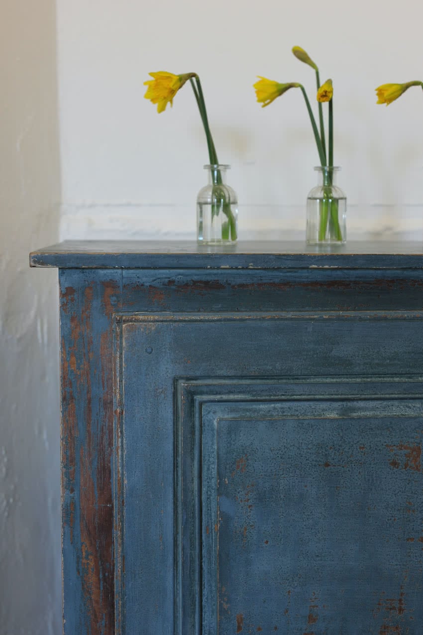 gorgeous french shelved pine cupboard, with tall feet and fairly distressed pretty blue paint.