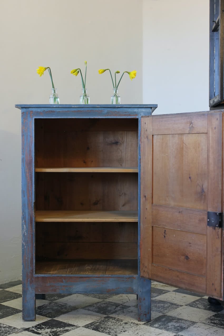gorgeous french shelved pine cupboard, with tall feet and fairly distressed pretty blue paint.