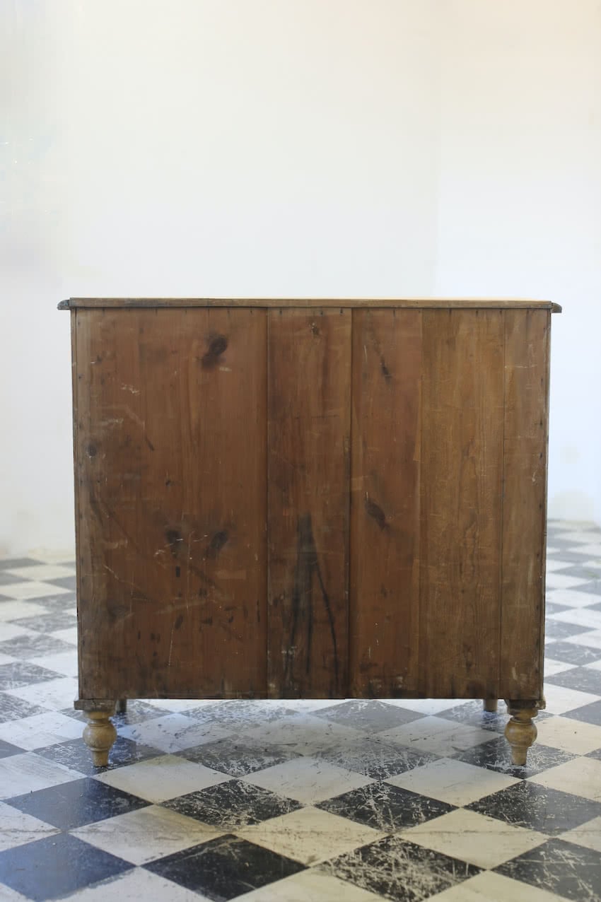 beautiful antique original painted pine english chest of drawers with contrasting black knobs and original turned feet.