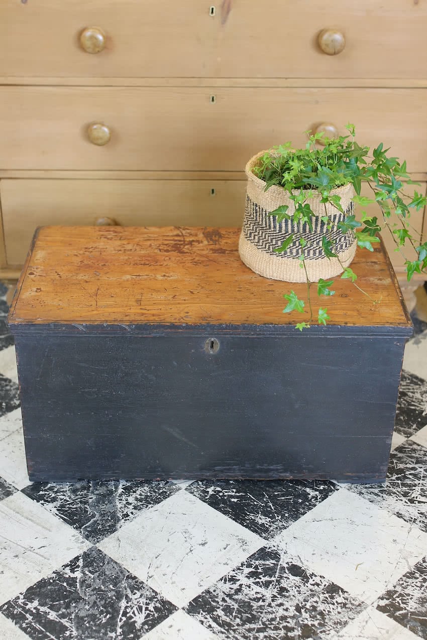 pretty english linen chest with original painted top, the interior painted in orange, the chest has the original ironwork hinges.