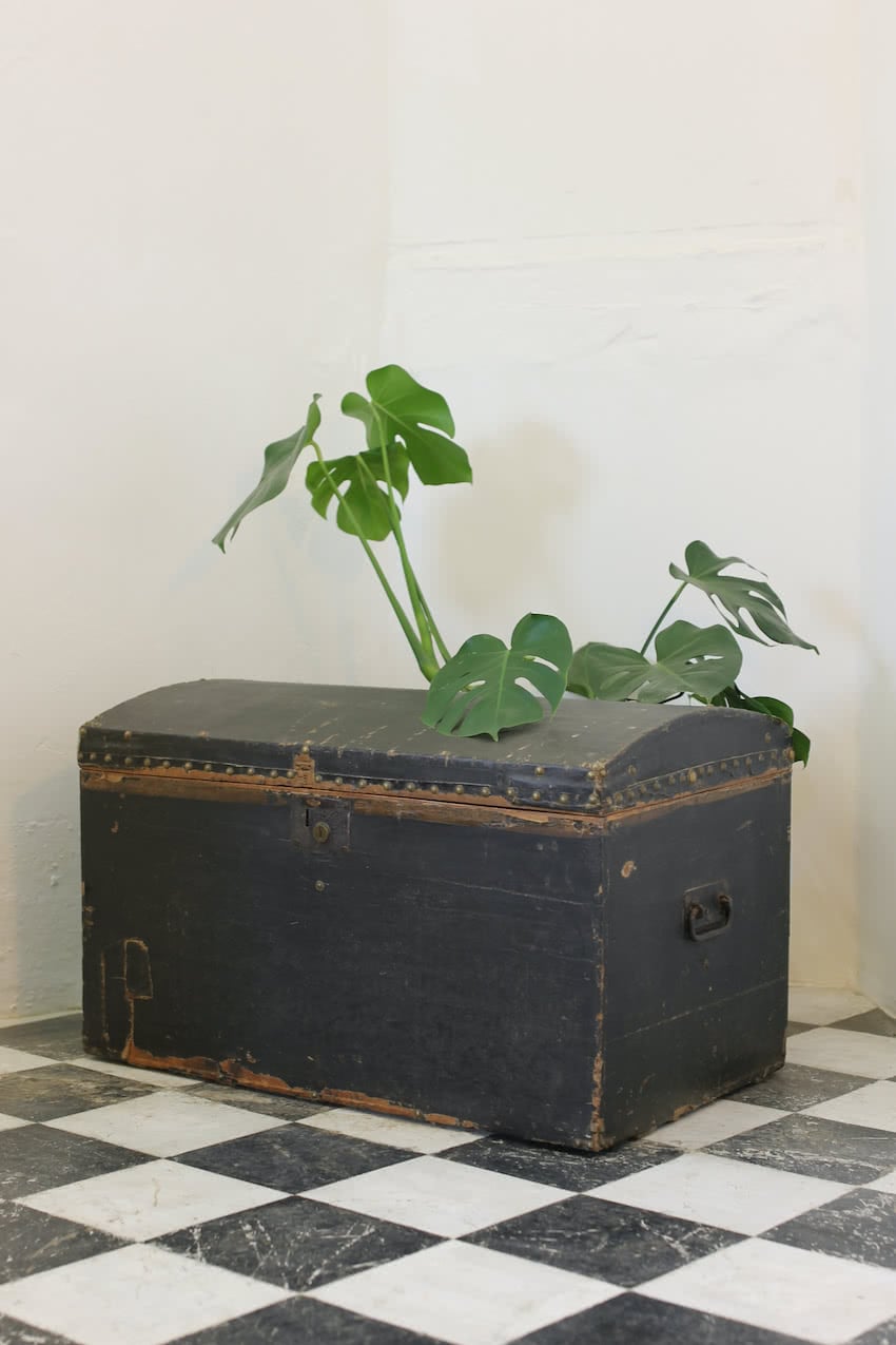linen covered & studded black trunk from dorset, vintage paper lined, ironwork handles &  wear and tear shown in photos.