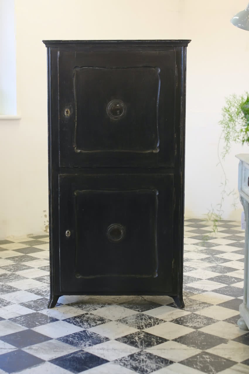 black two door cupboard with painted sage interior, shelves & three deep drawers, the cupboard sits on small shaped feet.