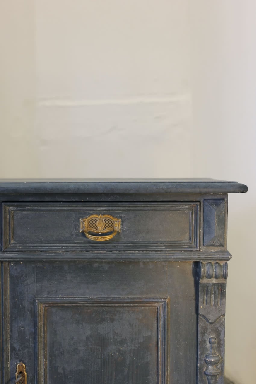 pretty two drawer painted antique european cupboard base with shelved & partly painted deep red interior, the cupboard has brass handles and escutcheon.