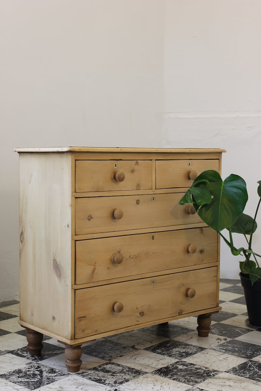 pretty english stripped & restored honey coloured pine chest of drawers with original turned knobs and darker turned feet.