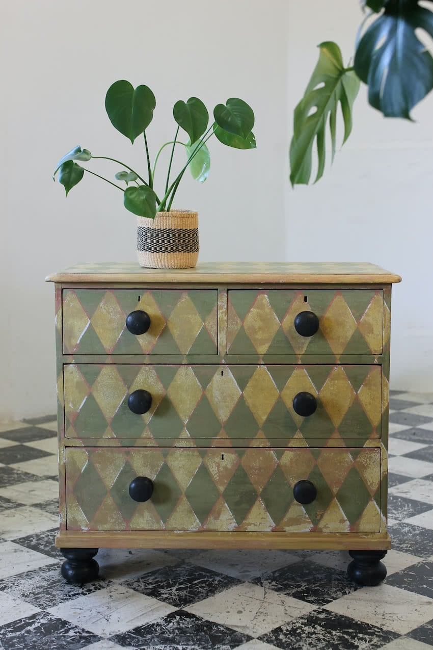english geometric pine chest with contrasting knobs and feet with pretty vintage Laura Ashley wallpaper lining.