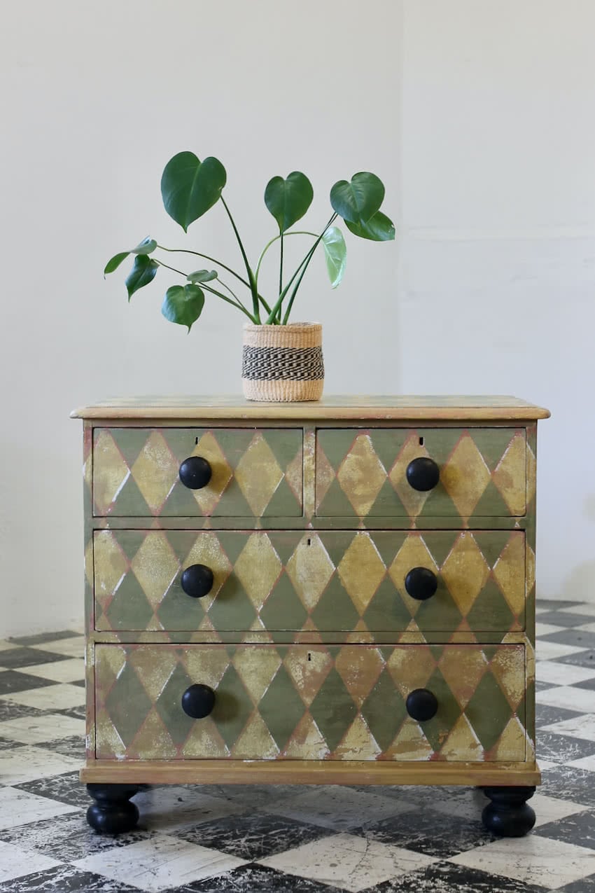 english geometric pine chest with contrasting knobs and feet with pretty vintage Laura Ashley wallpaper lining.