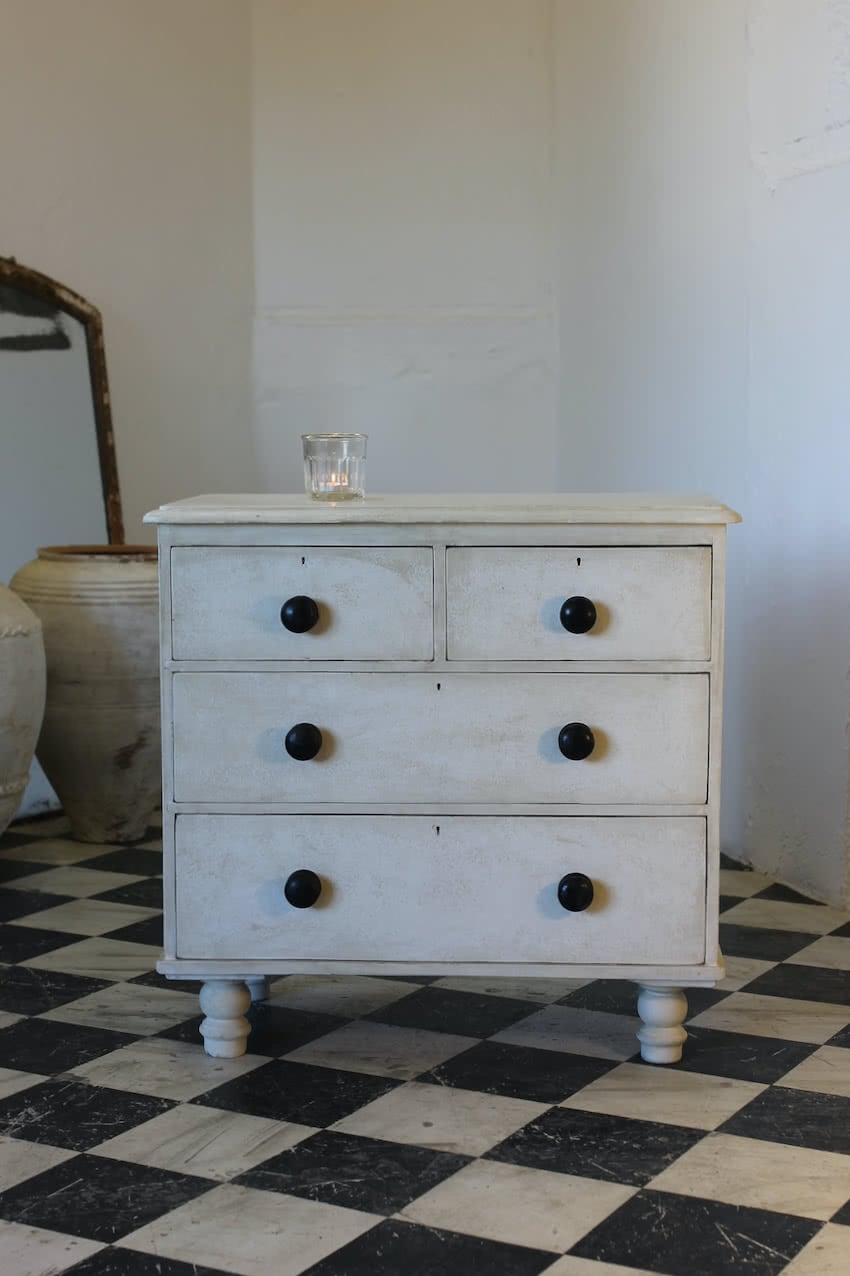 cute white victorian pine chest of drawers with black contrasting handles and classically turned feet