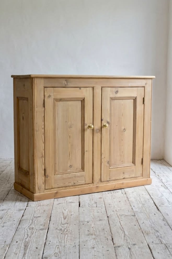 gorgeous very clean english pine cupboard two door base with one long original shelf inside and two brass round knobs.