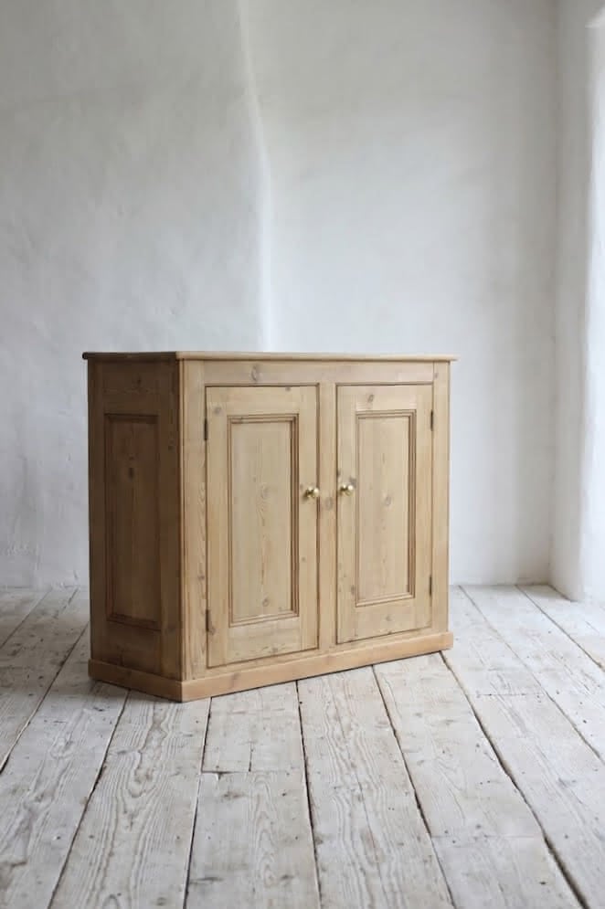 gorgeous very clean english pine cupboard two door base with one long original shelf inside and two brass round knobs.