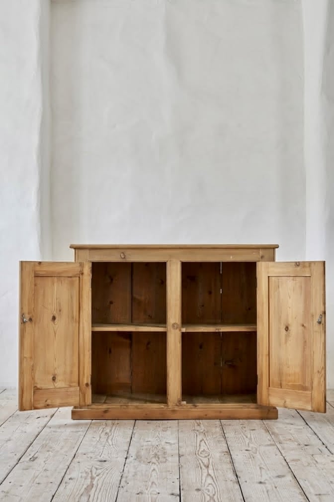gorgeous very clean english pine cupboard two door base with one long original shelf inside and two brass round knobs.