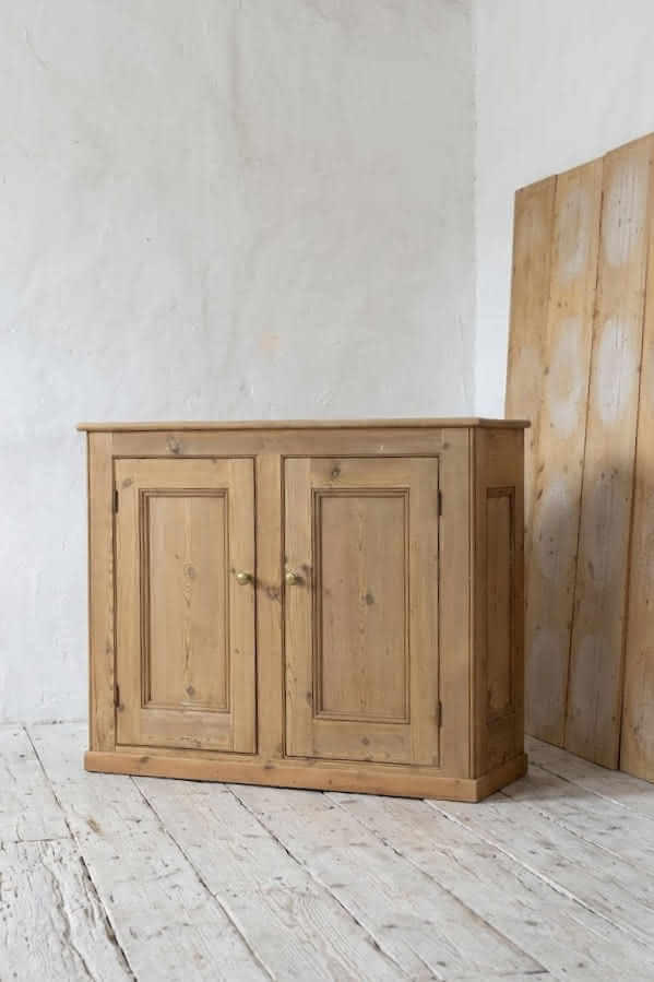 gorgeous very clean english pine cupboard two door base with one long original shelf inside and two brass round knobs.