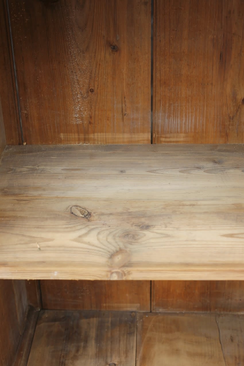 gorgeous very clean english pine cupboard two door base with one long original shelf inside and two brass round knobs.