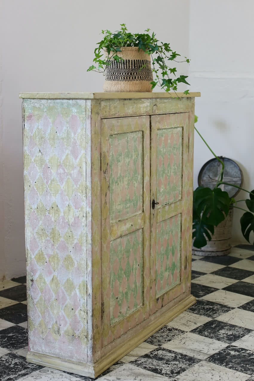 beautiful english hand scraped original painted pine cupboard with a geometric pattern, the interior & shelves have been painted in an off white.