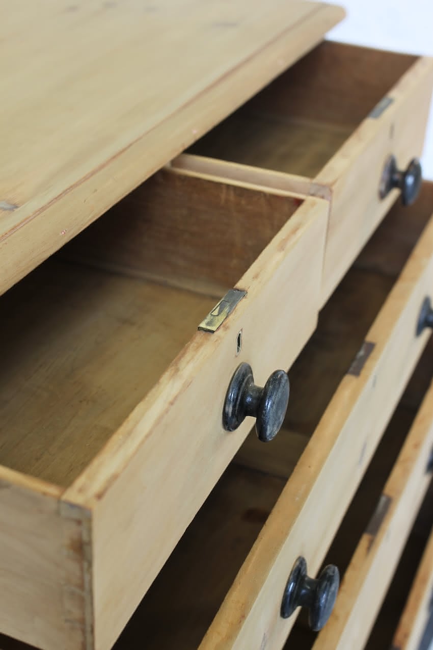 gorgeous looking stripped pine restored victorian chest with five graduating drawers & mostly original dark wooden knobs, & new feet.