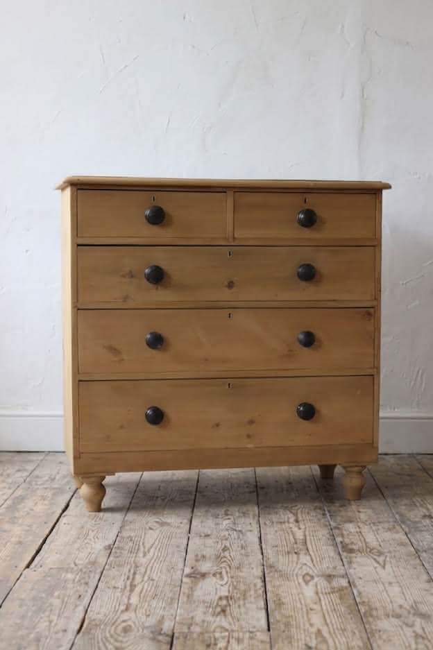 gorgeous looking stripped pine restored victorian chest with five graduating drawers & mostly original dark wooden knobs, & new feet.