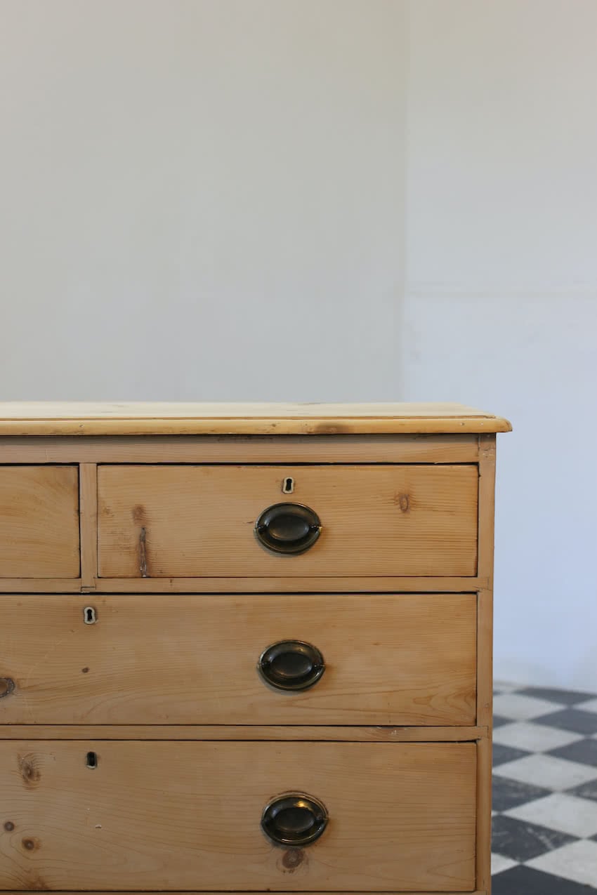 restored english antique pine chest of five graduating drawers with brass oval handles & pretty new tulip shaped feet.