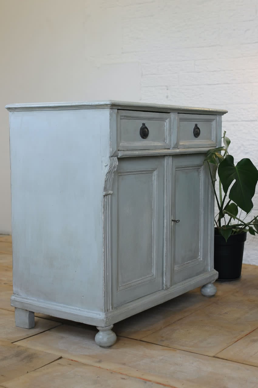 blue two drawer european pine cupboard base with a shelf inside and part painted interior, old handles & turned feet.