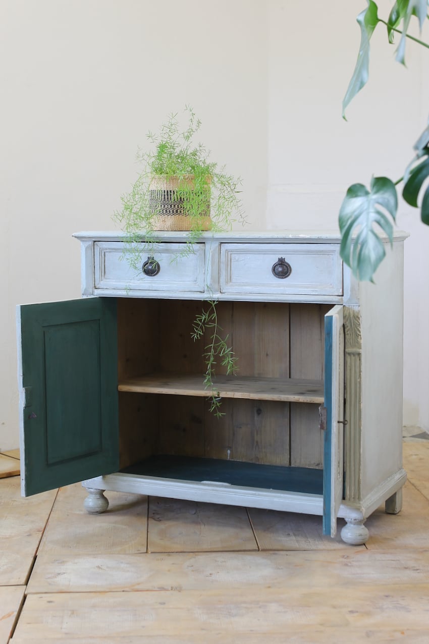 blue two drawer european pine cupboard base with a shelf inside and part painted interior, old handles & turned feet.