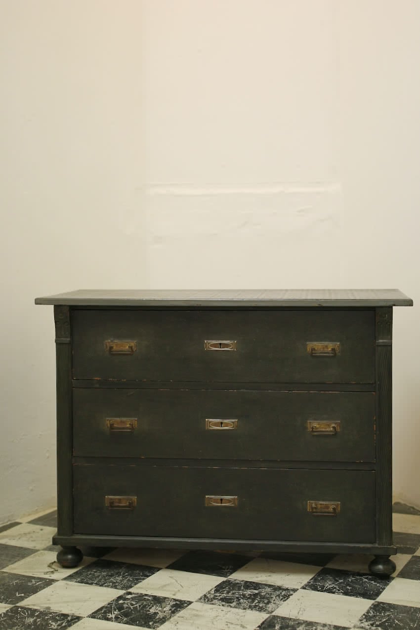 striking european chest with geometric pattern on the top, brass handles & escutcheons, round turned feet at front.