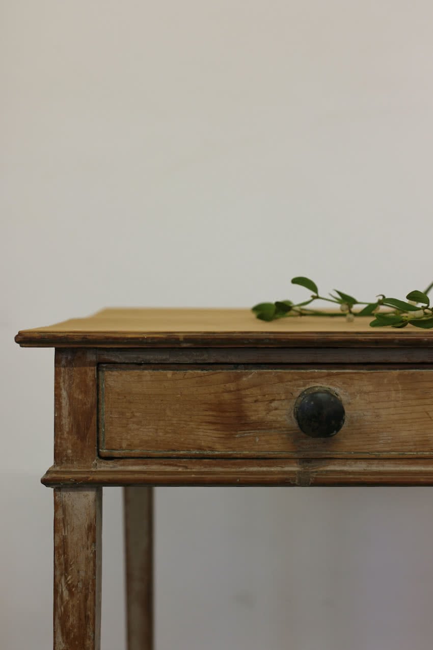 beautiful sympathetically restored table with wide drawer, wooden knobs, one has a bit missing, slender tapering legs and original paint.