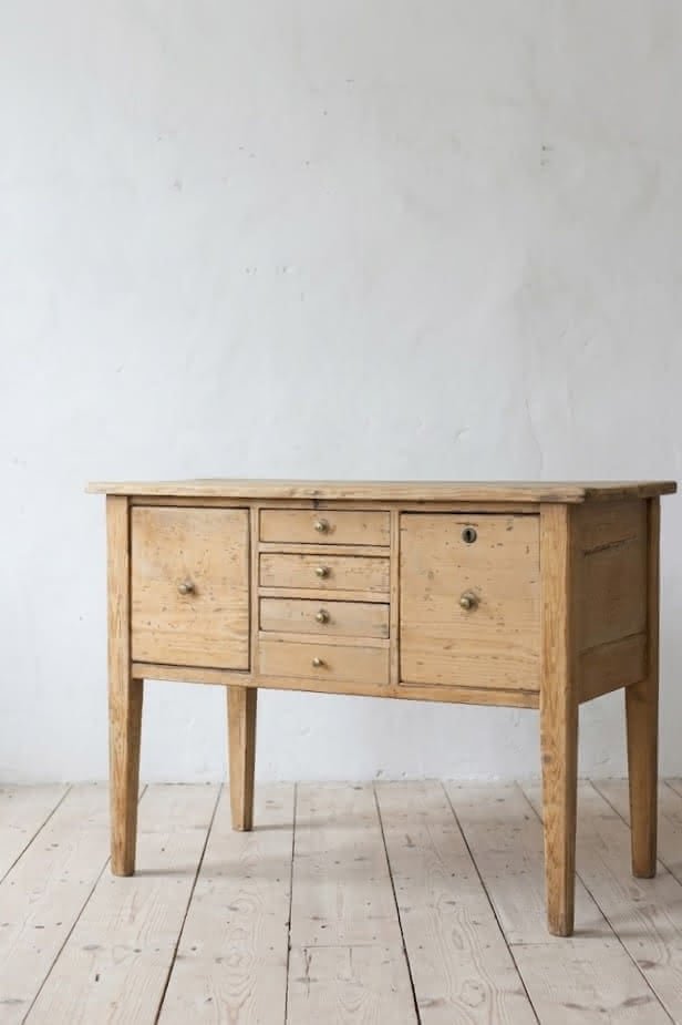 charming restored pine rustic looking console table with two deep drawers & three shallow plus a faux drawer.