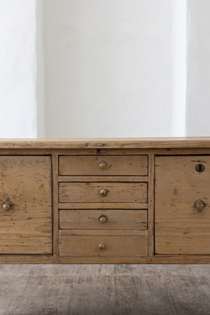 charming restored pine rustic looking console table with two deep drawers & three shallow plus a faux drawer.