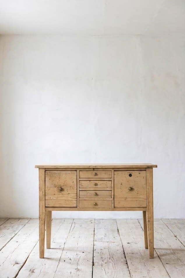 charming restored pine rustic looking console table with two deep drawers & three shallow plus a faux drawer.