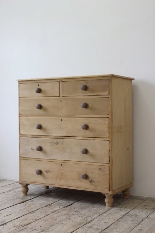 beautiful restored very large pine chest with six graduating drawers, contrasting wooden knobs and new tulip shaped turned feet.