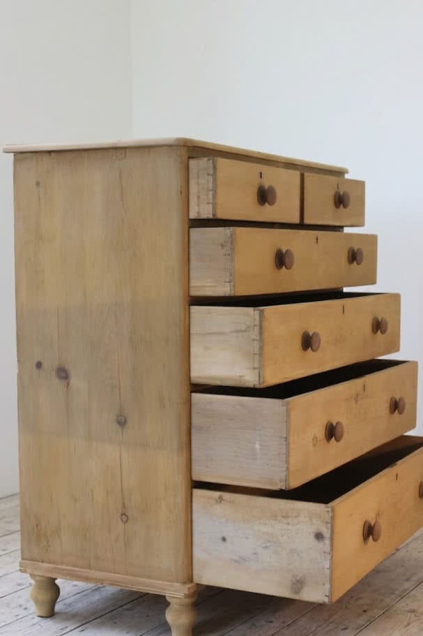 beautiful restored very large pine chest with six graduating drawers, contrasting wooden knobs and new tulip shaped turned feet.