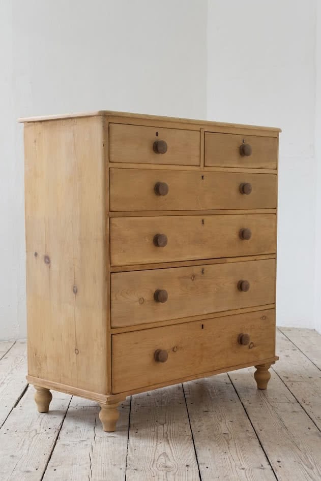 beautiful restored very large pine chest with six graduating drawers, contrasting wooden knobs and new tulip shaped turned feet.