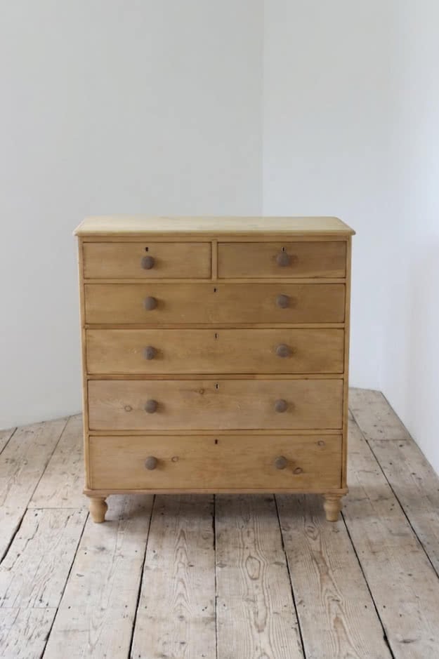 beautiful restored very large pine chest with six graduating drawers, contrasting wooden knobs and new tulip shaped turned feet.