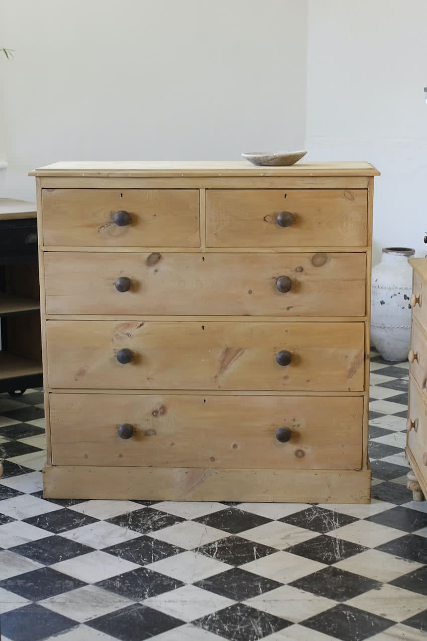very large beautiful restored rare pine chest of drawers with contrasting wooden knobs and large plinth.