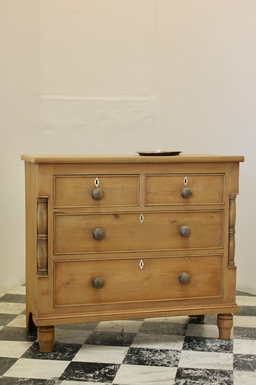 very pretty little chest with columns, original knobs, ivory diamond shaped escutcheons & uniquely shaped back feet, the chest has a dry finish.