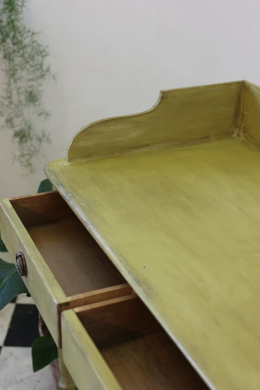 very pretty pine english galleried two drawer side table with brass handles, painted a shade of Lichen with a slight distressed finish.