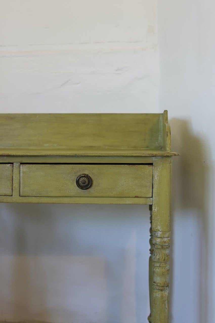 very pretty pine english galleried two drawer side table with brass handles, painted a shade of Lichen with a slight distressed finish.