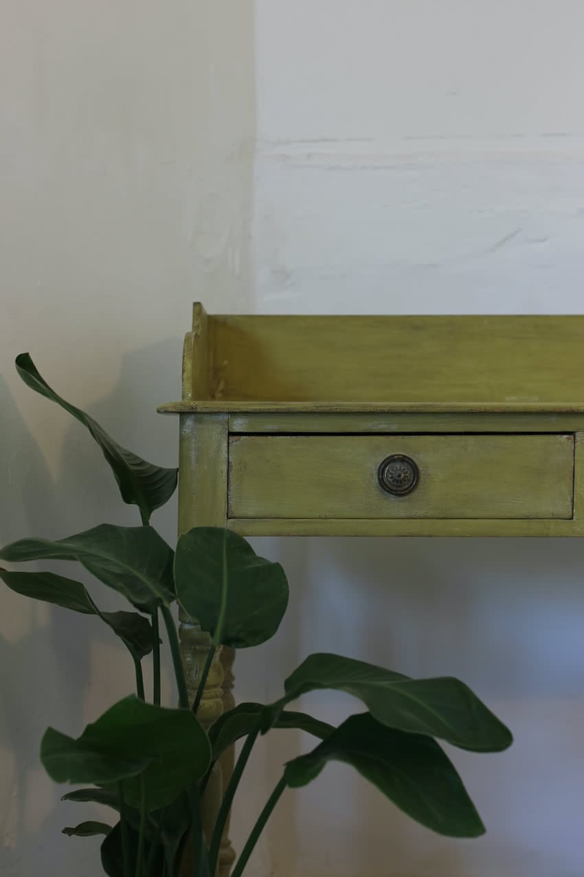 very pretty pine english galleried two drawer side table with brass handles, painted a shade of Lichen with a slight distressed finish.