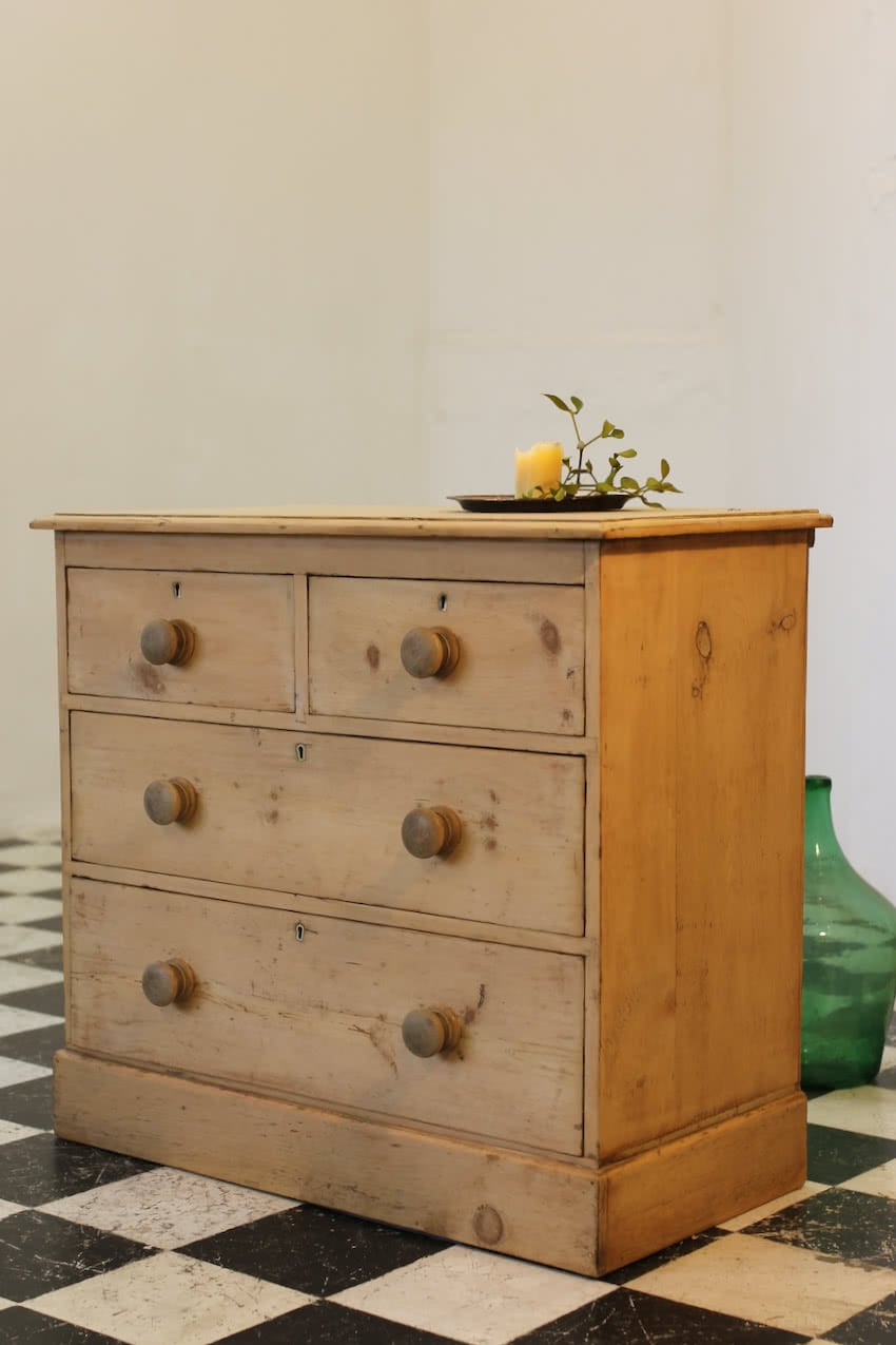 victorian restored rustic looking pine chest with four graduating drawers, wooden knobs and a deep plinth.