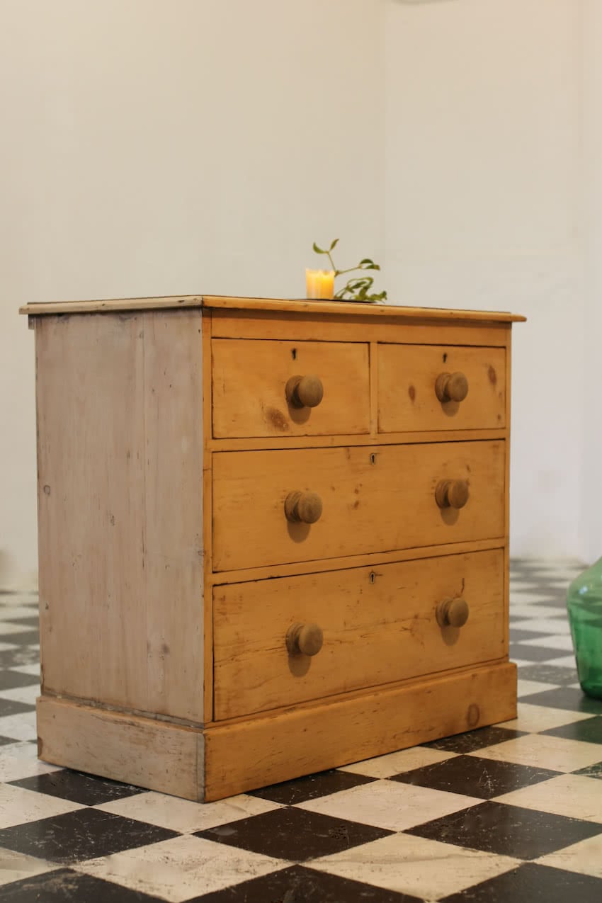 victorian restored rustic looking pine chest with four graduating drawers, wooden knobs and a deep plinth.