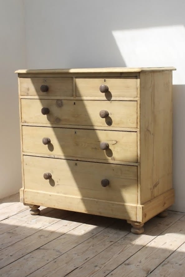 lovely looking rustic victorian pine large chest of five graduating deep drawer.s with wooden knobs and original round bun feet.