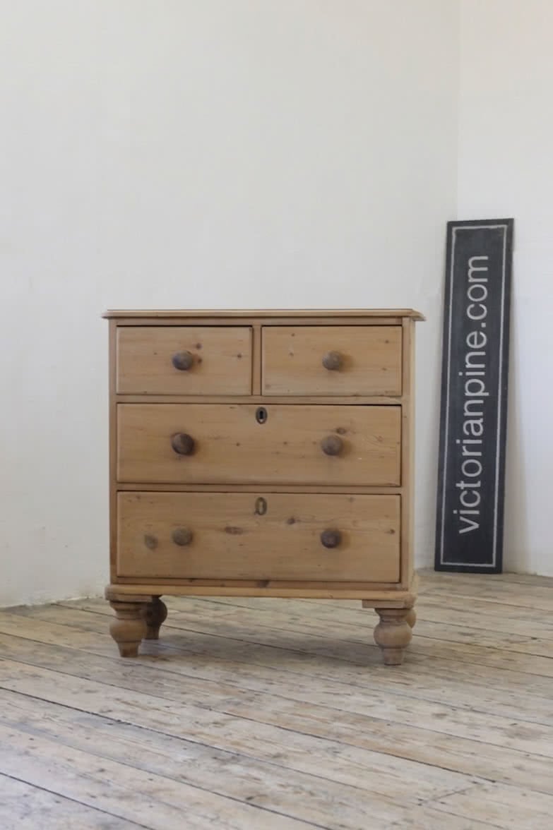 antique pine chest restored with original knobs and feet, brass keyplates added later.