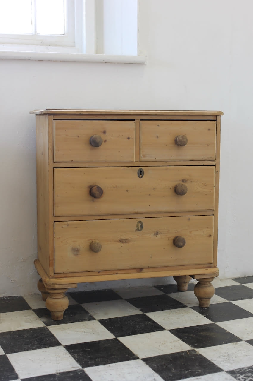 restored pine victorian large chest of drawers with original wooden knobs and new turned tulip shaped feet.antique pine chest restored with original knobs and feet, brass keyplates added later.