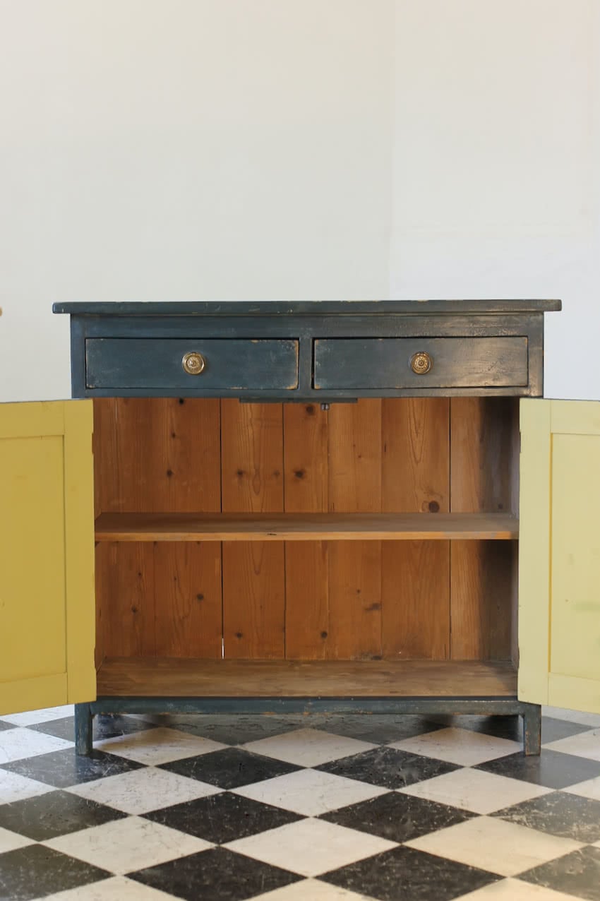 blue painted pine cupboard with two drawers with a shelf, a geometric patterned top & interior doors and drawers painted in Lichen. 