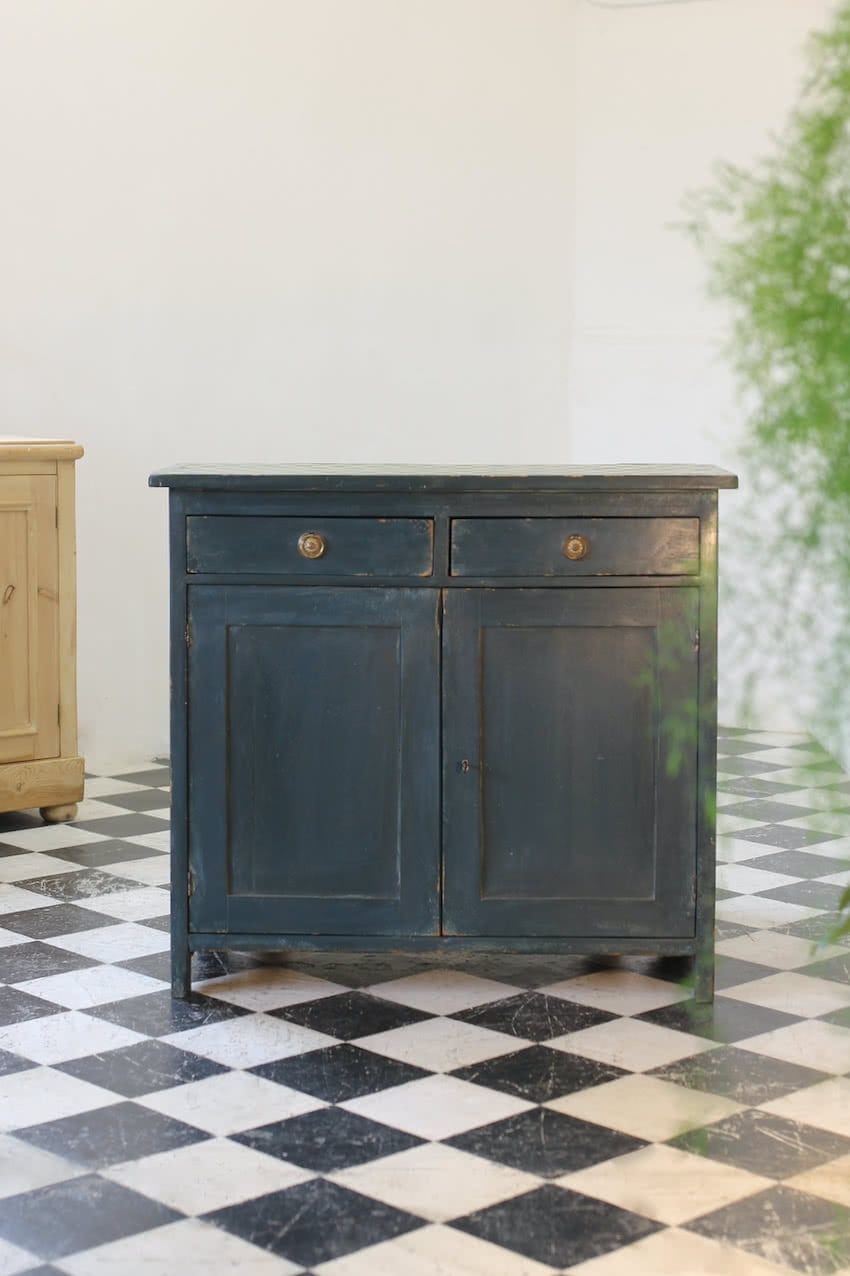 blue painted pine cupboard with two drawers with a shelf, a geometric patterned top & interior doors and drawers painted in Lichen. 