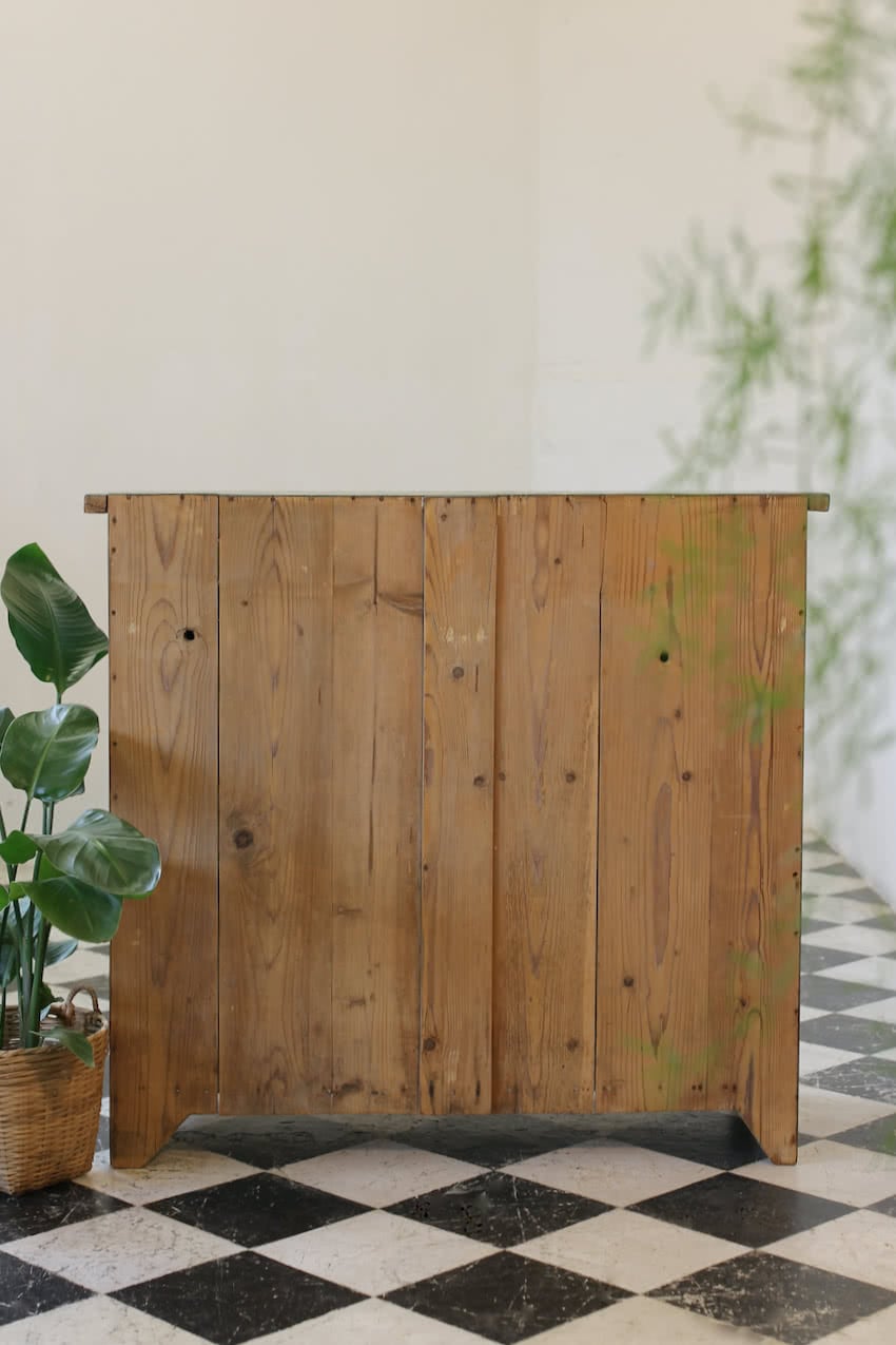 blue painted pine cupboard with two drawers with a shelf, a geometric patterned top & interior doors and drawers painted in Lichen. 