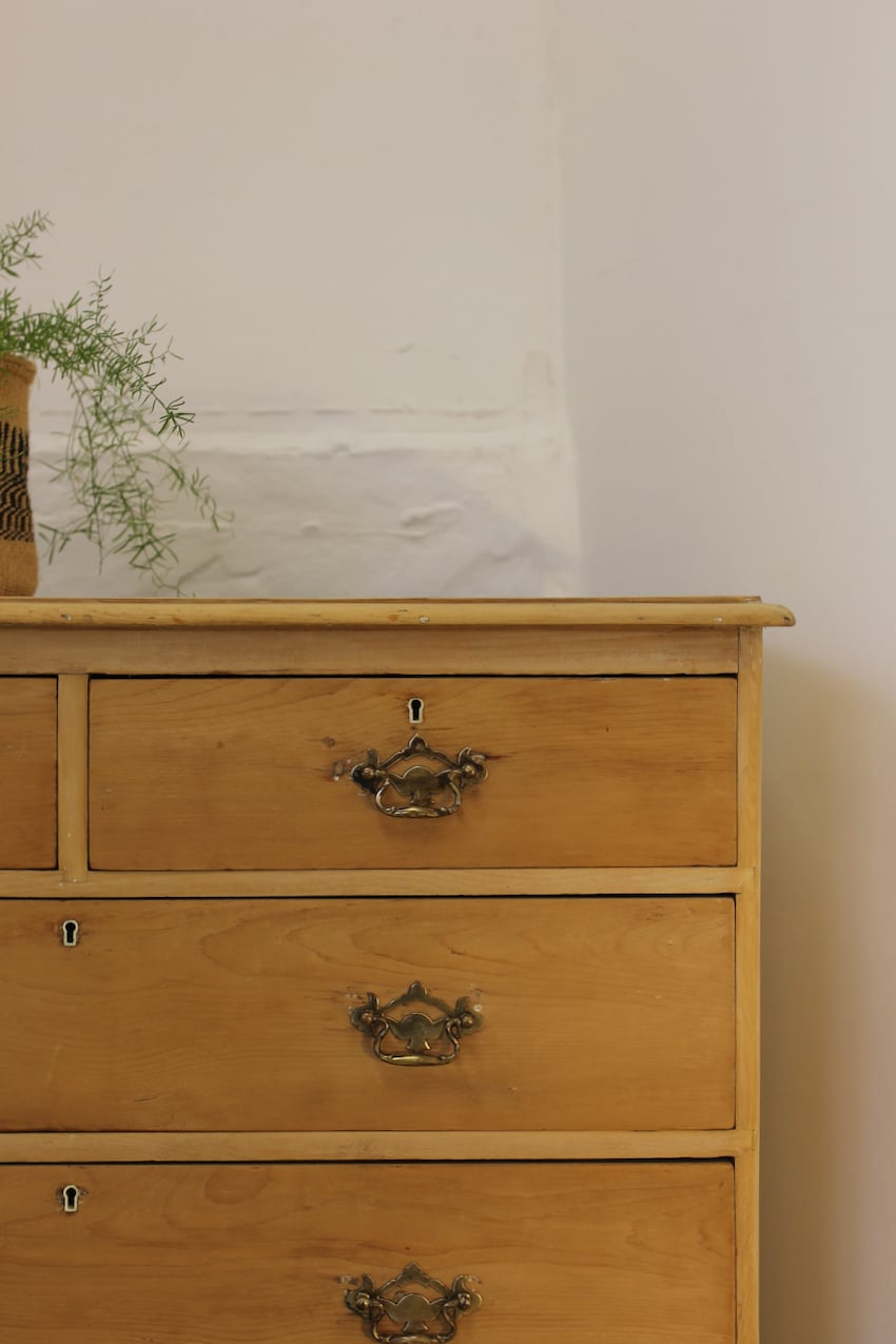pretty victorian large chest in lovely honey coloured pine, with gentle graduating drawers, typical shaped feet and brass handles.