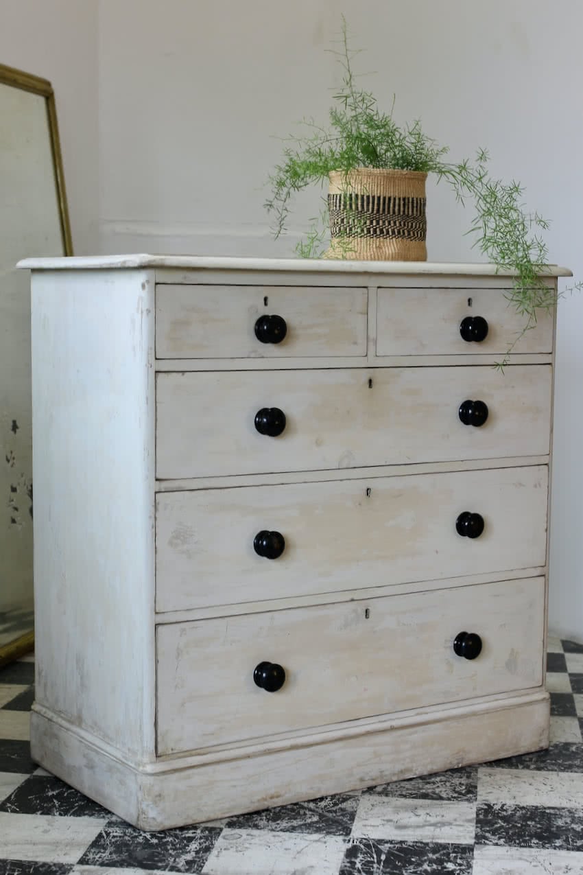 beautiful restored large victorian pine chest hand scraped to reveal original old white and cream paint, the chest has contrasting black wooden knobs.